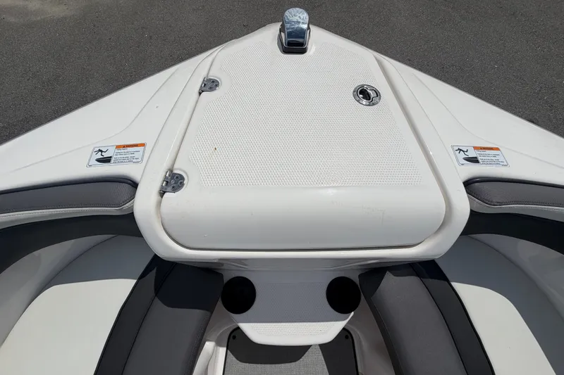 Slide: The Image of 2022 Yamaha Boats AR210 bow area with storage compartment and safety labels. - 41