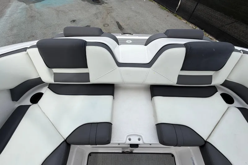 Slide: The Image of 2022 Yamaha Boats AR210 interior seating with black and white upholstery. - 53