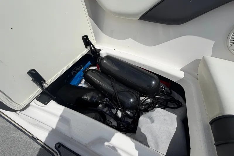 Slide: The Image of Storage compartment of 2022 Yamaha AR210 boat with fenders and accessories. - 47