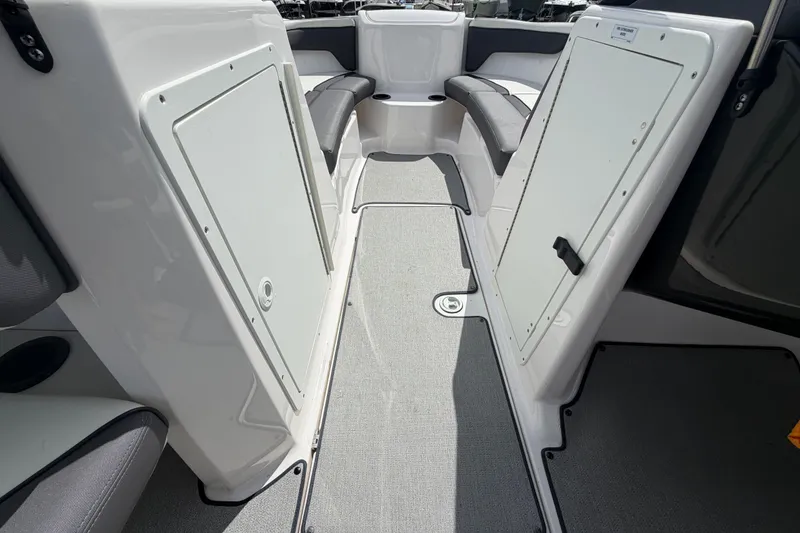 Slide: The Image of 2022 Yamaha Boats AR210 interior with seating and storage compartments. - 31