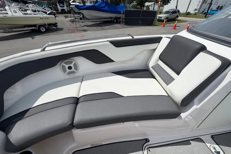 Slide: The Image of 2022 Yamaha Boats AR210 interior seating with sleek design and comfortable cushions. - 44