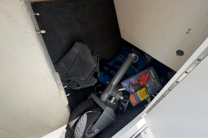 Slide: The Image of Storage compartment of a 2022 Yamaha AR210 boat with equipment and accessories. - 35
