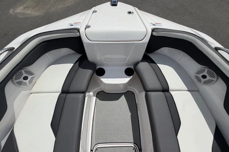Slide: The Image of 2022 Yamaha Boats AR210 interior with cushioned seating and cup holders. - 40