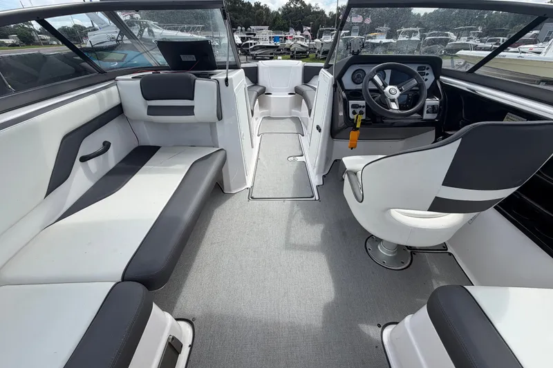 Slide: The Image of 2022 Yamaha AR210 boat interior with seating and steering console. - 17