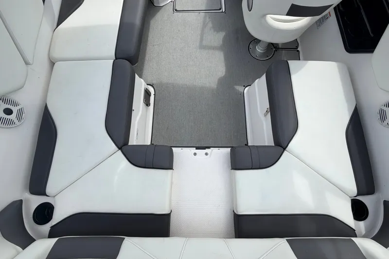 Slide: The Image of 2022 Yamaha AR210 boat interior with gray and white seating arrangement. - 16