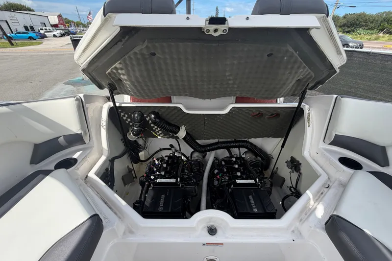 Slide: The Image of 2022 Yamaha Boats AR210 engine compartment with dual engines and seating area. - 54