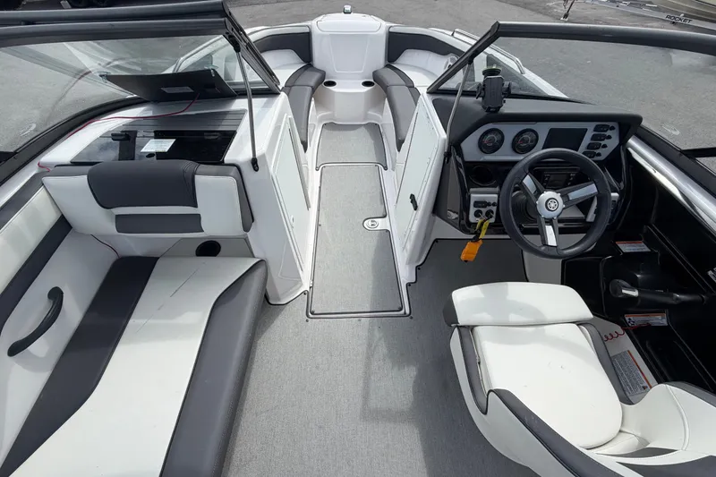 Slide: The Image of 2022 Yamaha AR210 boat interior with sleek seating and modern dashboard design. - 21