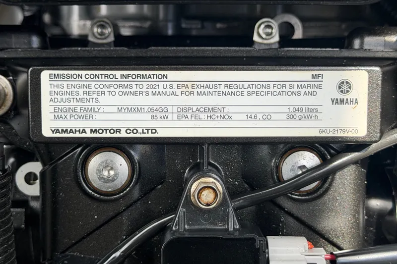 Slide: The Image of Close-up of 2022 Yamaha AR210 engine label displaying emission control information. - 64