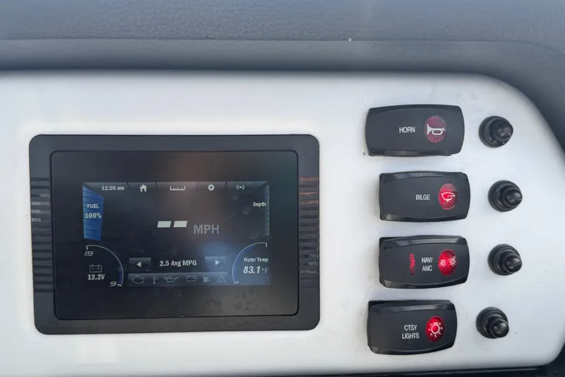 Slide: The Image of Dashboard of a 2022 Yamaha Boats AR210 showing controls and digital display. - 26