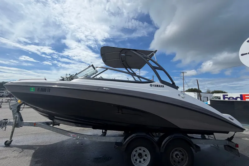 Slide: The Image of 2022 Yamaha AR210 boat on trailer under cloudy sky. - 6