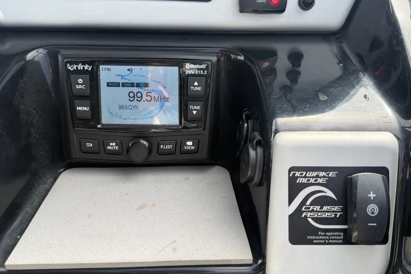 Slide: The Image of Yamaha AR210 2022 dashboard with Infinity radio and Cruise Assist controls. - 28