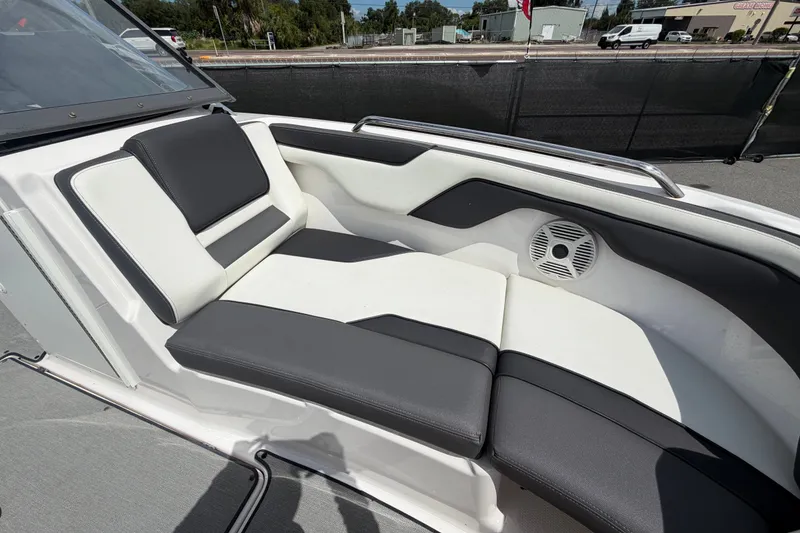 Slide: The Image of 2022 Yamaha Boats AR210 interior seating with black and white upholstery and speaker. - 46