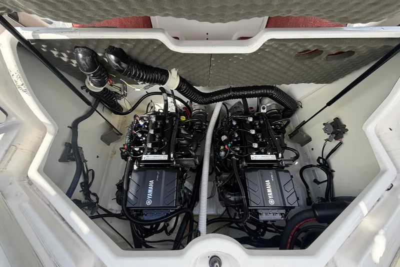 Slide: The Image of 2022 Yamaha Boats AR210 engine compartment with dual engines and wiring. - 55