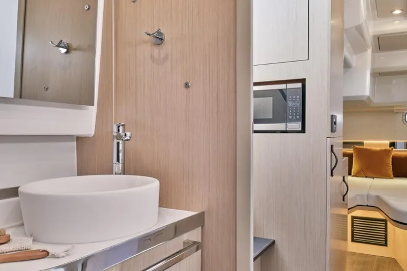Slide: The Image of Manufacturer Provided Image: Modern bathroom and interior of 2025 Four Winns TH36 yacht, featuring sleek design and amenities. - 7
