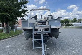 Slide: The Image of 2002 Fisher Freedom 220 DLX FISH pontoon boat on trailer, parked outdoors. - 3