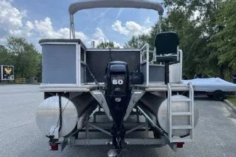 Slide: The Image of 2002 Fisher Freedom 220 DLX FISH pontoon boat with 60 HP motor, parked outdoors. - 5