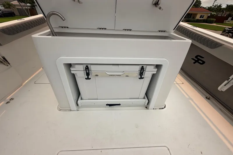 Slide: The Image of 2023 Sea Pro 320 DLX Offshore boat interior with storage compartment and sink. - 15