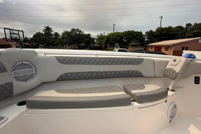 Slide: The Image of 2023 Sea Pro 320 DLX Offshore boat interior with cushioned seating and speaker system. - 35