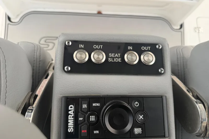 Slide: The Image of Control panel of 2023 Sea Pro 320 DLX Offshore boat with seat slide buttons. - 22
