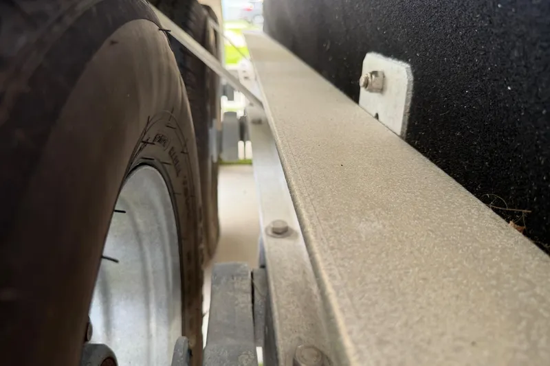 Slide: The Image of Close-up of a 2023 Sea Pro 320 DLX Offshore trailer tire and frame. - 52