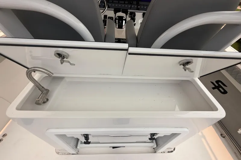 Slide: The Image of 2023 Sea Pro 320 DLX Offshore boat sink and storage area, featuring modern design and functionality. - 17