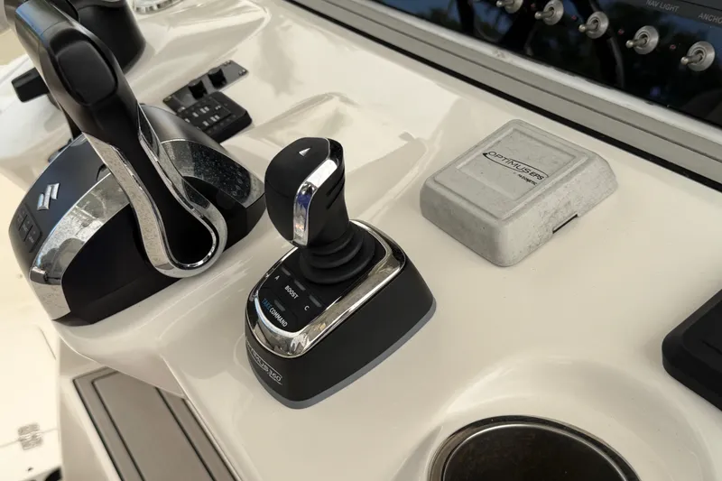 Slide: The Image of Control panel of 2023 Sea Pro 320 DLX Offshore boat with joystick and throttle. - 26