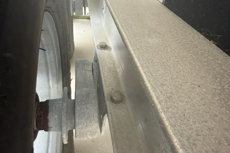Slide: The Image of Close-up of a 2023 Sea Pro 320 DLX Offshore trailer wheel and axle. - 53
