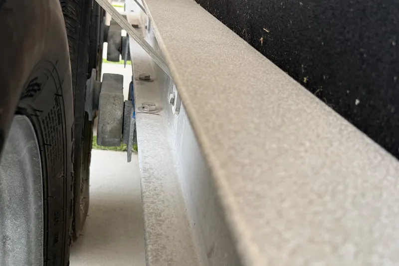 Slide: The Image of Close-up of a 2023 Sea Pro 320 DLX Offshore trailer tire and frame detail. - 51