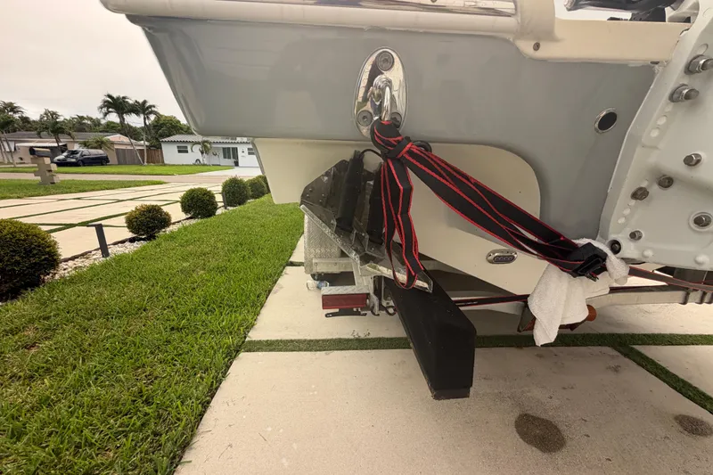 Slide: The Image of 2023 Sea Pro 320 DLX Offshore boat secured with straps on a driveway. - 6