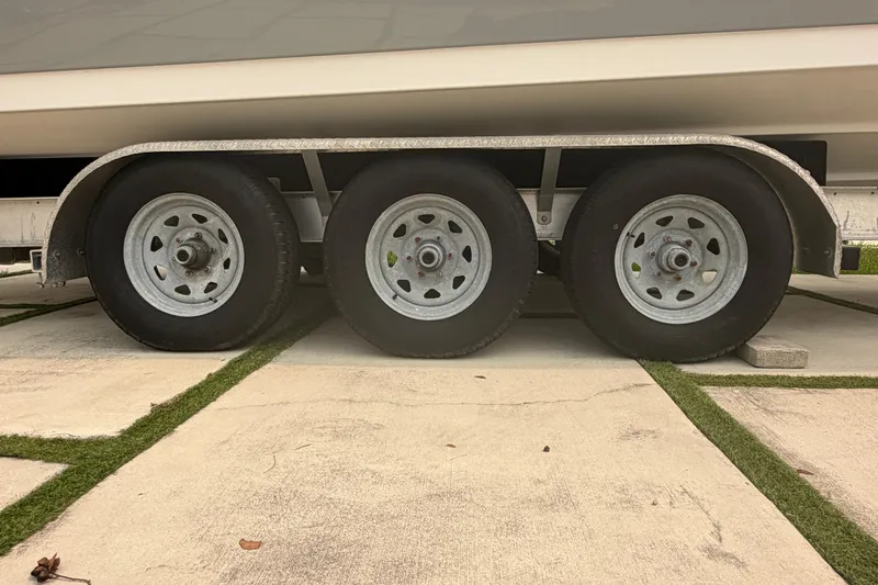 Slide: The Image of Triple-axle trailer for 2023 Sea Pro 320 DLX Offshore boat on concrete surface. - 50
