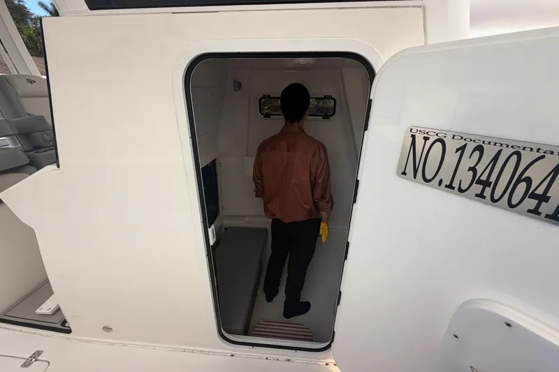 Slide: The Image of 2023 Sea Pro 320 DLX Offshore cabin entrance with USCG documentation number visible. - 29