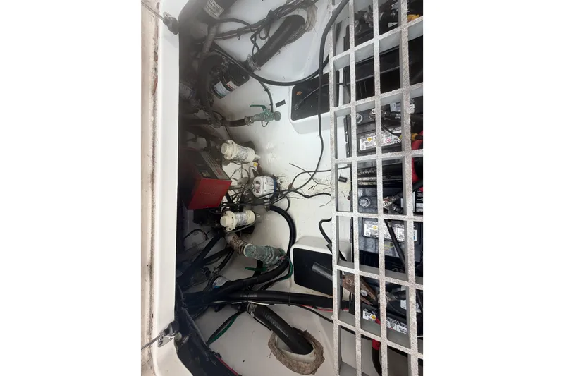 Slide: The Image of Engine compartment of 2023 Sea Pro 320 DLX Offshore boat, showing wiring and components. - 59