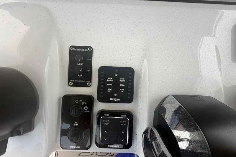 Slide: The Image of Control panel of 2023 Sea Pro 320 DLX Offshore boat with various switches and buttons. - 25
