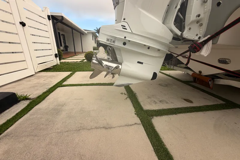 Slide: The Image of 2023 Sea Pro 320 DLX Offshore boat engine and propeller on a driveway. - 5