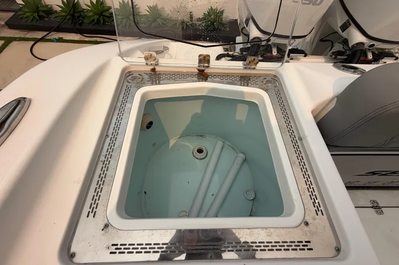 Slide: The Image of Livewell on 2023 Sea Pro 320 DLX Offshore boat, open lid, clean interior. - 45