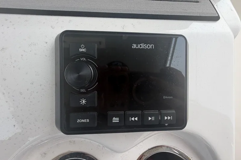 Slide: The Image of Audison audio control panel on 2023 Sea Pro 320 DLX Offshore boat dashboard. - 23