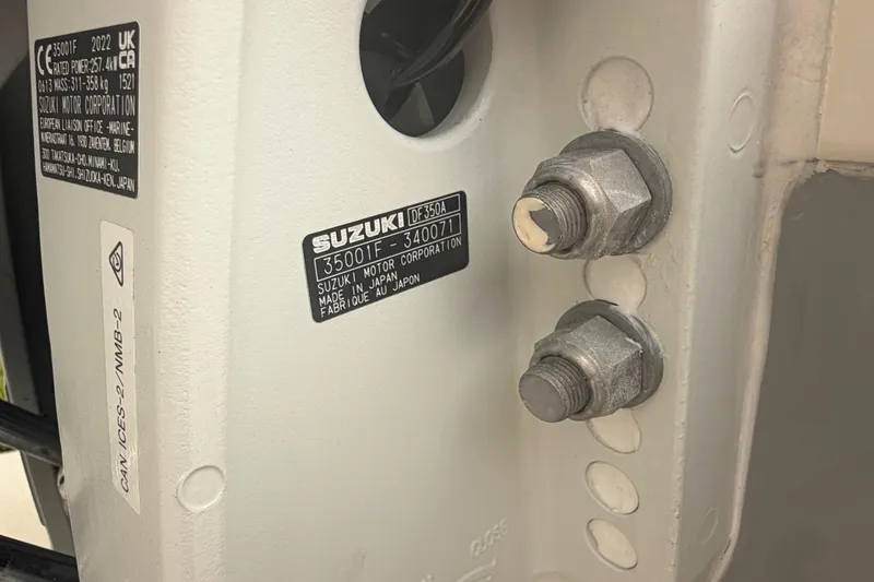 Slide: The Image of Close-up of Suzuki motor label and bolts on 2023 Sea Pro 320 DLX Offshore. - 64