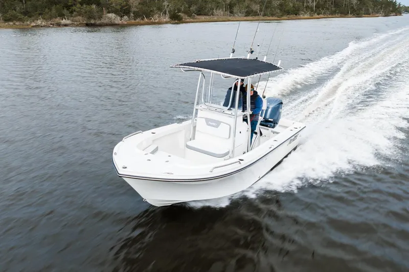 Slide: The Image of 2026 Parker 180 Coastal boat cruising on a serene waterway. - 1