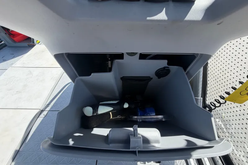Slide: The Image of Storage compartment of 2023 Sea-Doo Switch Cruise 21 with various items inside. - 44