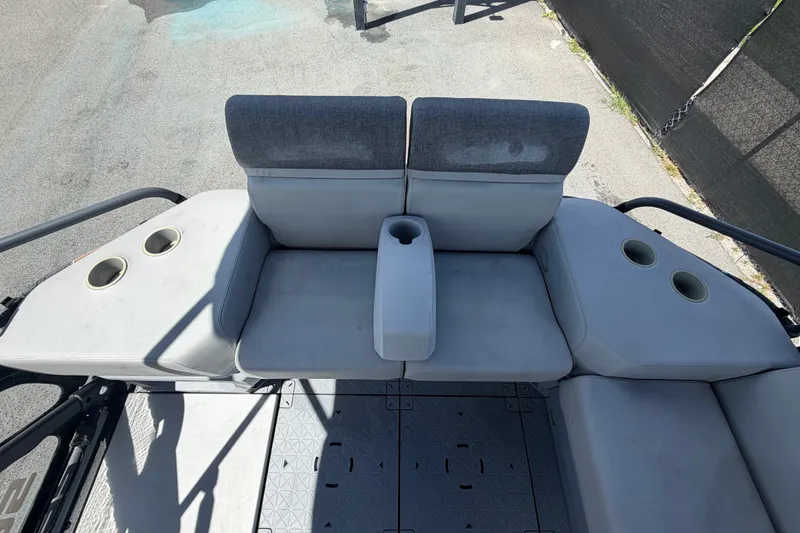 Slide: The Image of 2023 Sea-Doo Switch Cruise 21 seating area with cup holders and gray upholstery. - 25