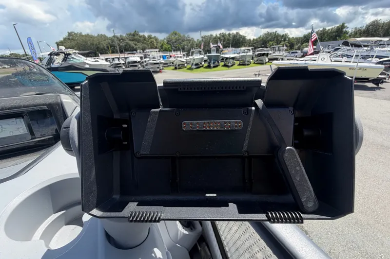 Slide: The Image of 2023 Sea-Doo Switch Cruise 21 dashboard with control panel, surrounded by boats and cloudy sky. - 42