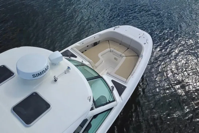 Slide: The Image of 2021 Boston Whaler 320 Vantage boat on water, featuring spacious seating and Simrad equipment. - 13