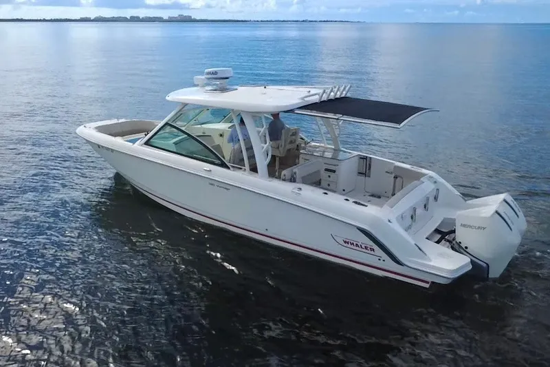 Slide: The Image of 2021 Boston Whaler 320 Vantage boat cruising on calm waters. - 5