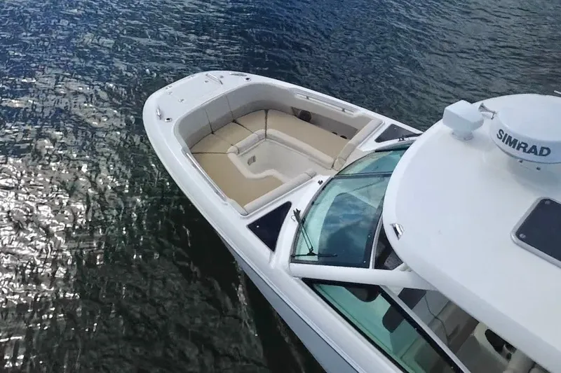 Slide: The Image of 2021 Boston Whaler 320 Vantage boat on water, featuring spacious seating and Simrad equipment. - 12