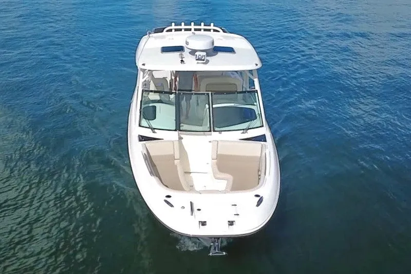 Slide: The Image of 2021 Boston Whaler 320 Vantage boat on clear blue water, aerial view. - 8