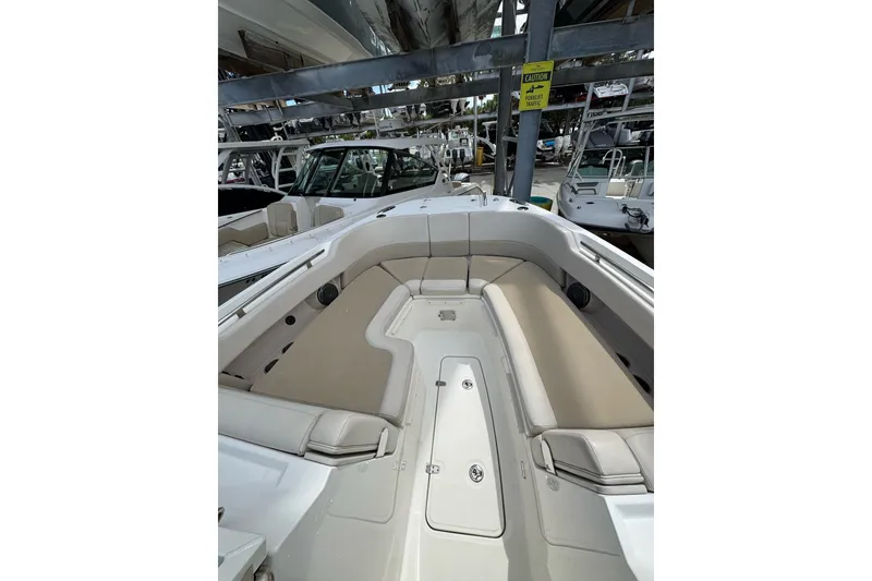 Slide: The Image of 2021 Boston Whaler 320 Vantage boat interior with beige seating and storage compartments. - 78