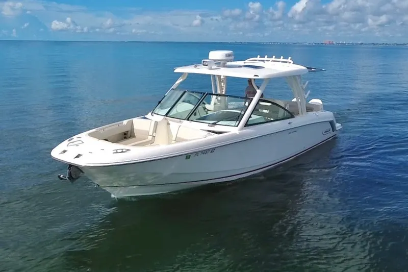 Slide: The Image of 2021 Boston Whaler 320 Vantage boat cruising on calm blue waters. - 7