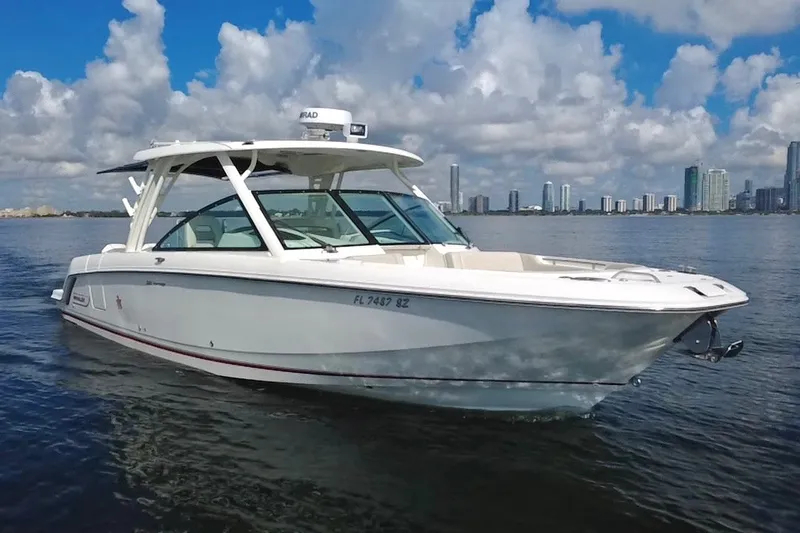 The Image of 2021 Boston Whaler 320 Vantage boat on water with city skyline background. - 0