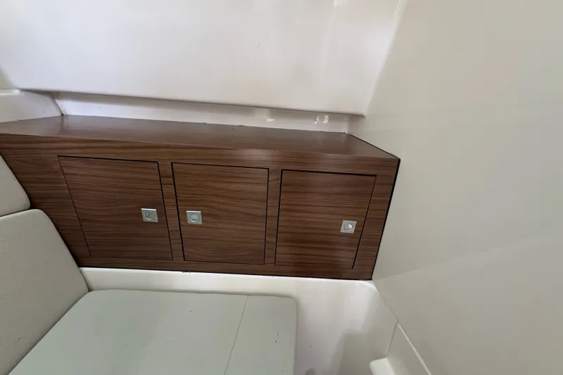 Slide: The Image of Interior storage cabinets on a 2021 Boston Whaler 320 Vantage boat. - 71
