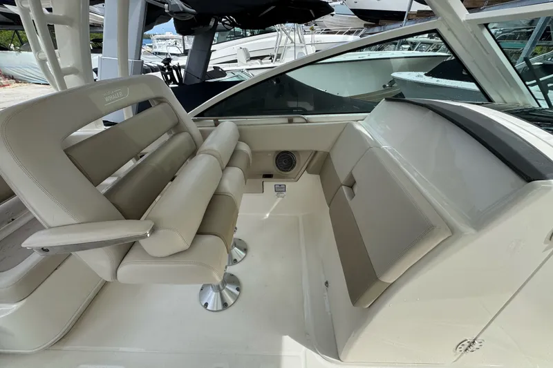 Slide: The Image of Interior seating of a 2021 Boston Whaler 320 Vantage boat, featuring beige upholstery. - 67